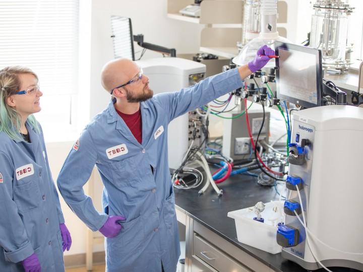 Two students analyze data in lab